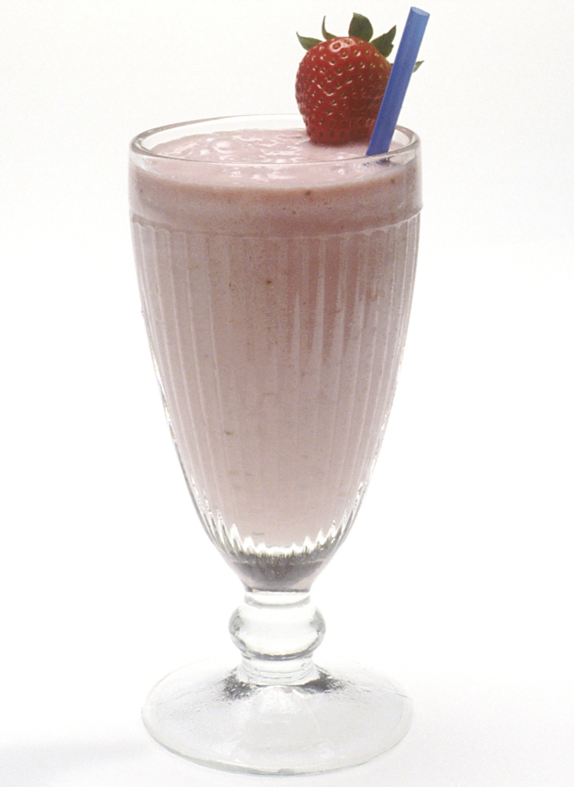 Pink strawberry milkshake in a clear glass